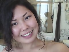 Chinese cutie takes off her clothes in the kitchen